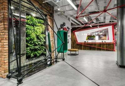 Open reception area with a large vertical garden and architectural metal framing.