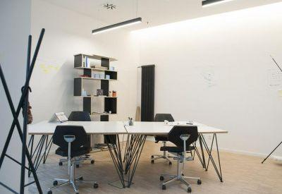 Modern meeting table with architectural wire legs and designer chairs.