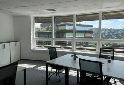 Bright corner office with large windows and city views.