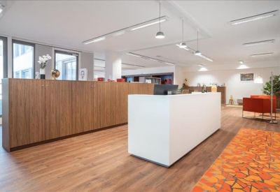 Bright reception area featuring a white front desk and warm wooden accents.