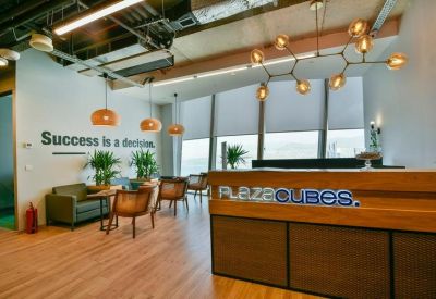 Polished reception desk featuring a wooden facade and geometric light fixture.