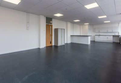 Breakout space featuring a kitchen island and a storage cabinet.