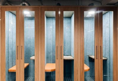 Row of private acoustic phone booths with wooden frames and blue padding.