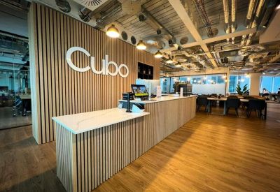 Modern reception area with a slatted wood feature wall and white stone-top desk.