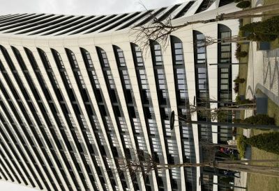 Exterior view of the white curved facade of Allure Tower.