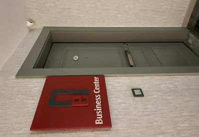 Branded Business Center signage and a wall-mounted tablet.