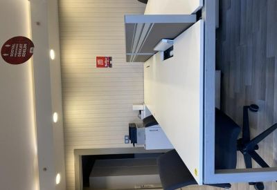 Close-up of a modern white desk station with privacy dividers.