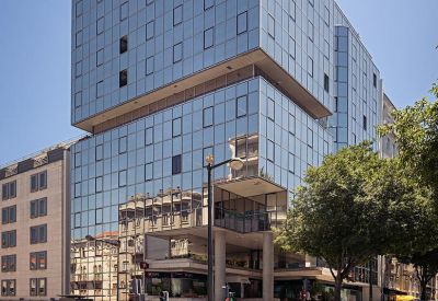 Exterior of the glass-facade building at Avenida António Augusto Aguiar, 122C, Lisbon.