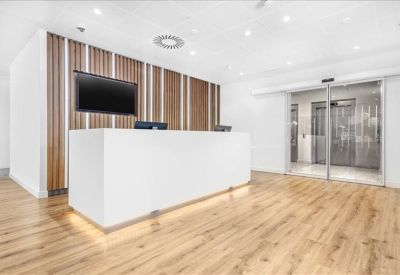 Sleek white reception desk set against a vertical wood-slat feature wall.