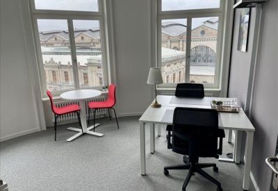 Bright breakout space featuring a large wooden communal table and contemporary dome lighting.
