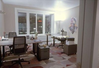 Private office suite with dark grey desks and a large window providing natural light.