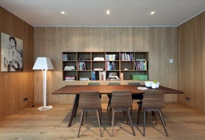 Private dining or meeting space with wood-paneled walls and a matching timber table.