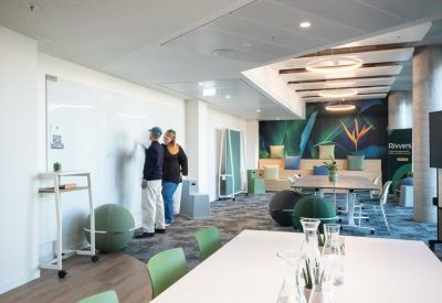 Creative breakout area with a whiteboard, exercise ball seating, and vibrant tropical mural.