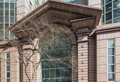 Exterior entrance of Beaufort House, 15 Saint Botolph Street, featuring a large glass arch and stone facade.