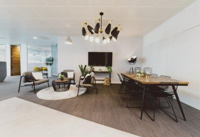 Breakout lounge with mid-century furniture and a striking black and white chandelier.