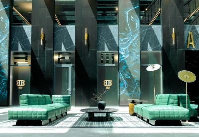 Modern lounge area featuring vibrant green modular sofas and artistic wall panels.