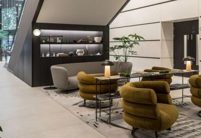 Modern lounge with mustard velvet armchairs and built-in shelving.
