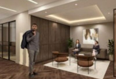 Elegant reception waiting area with plush seating, wood paneling, and warm lighting.