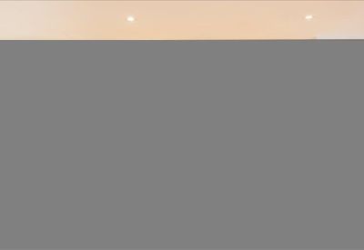 Close-up of a neutral-toned office wall with recessed lighting.