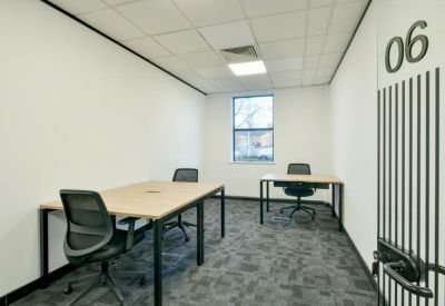 Private internal office suite with two wood-finish desks and grey ergonomic chairs.