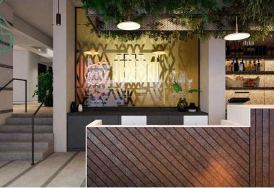 Modern reception desk with diagonal wood paneling and hanging greenery installations.