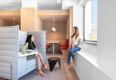 Breakout area featuring a high-back privacy sofa and window seating.