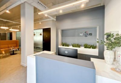 Sleek reception area featuring a grey front desk and integrated wall planters.