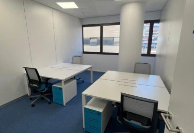 Modern private office suite with two white desks and blue accents.