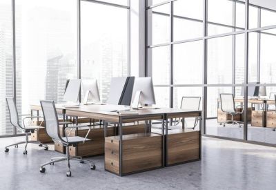 Bright open-plan workspace with glass partitions and wooden desks.