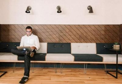 Single workstation bench with integrated power outlets against a wood-paneled wall.