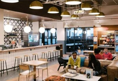 Modern café and lounge area with a tiled bar, leather seating, and decorative pendant lighting.