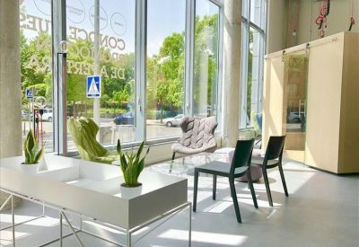 Bright reception and lounge area with diverse seating options and large windows.