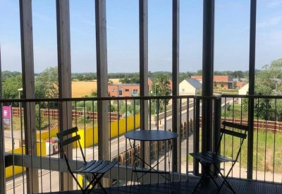 Wooden balcony at The Eco Business Centre, Elmsbrook overlooking Bicester countryside.
