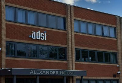 Close-up of the brick facade and signage at Alexander House.