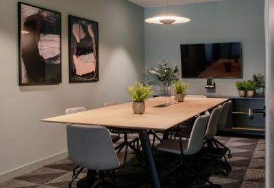 Modern meeting room at City Quarter, Lapps Quay, with wooden table and abstract art.