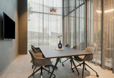 Private office space with two desks and view of the city.