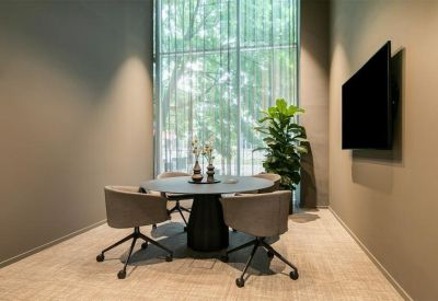 Small meeting room with a round table and a large window.