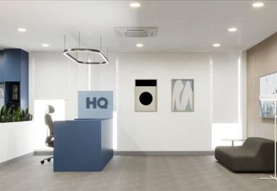 Reception desk with HQ branding and modern geometric pendant lighting.