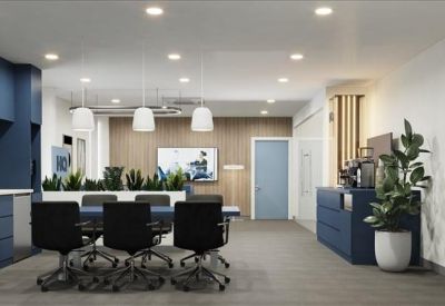 Open-plan workspace with a large communal desk and wall-mounted artwork.