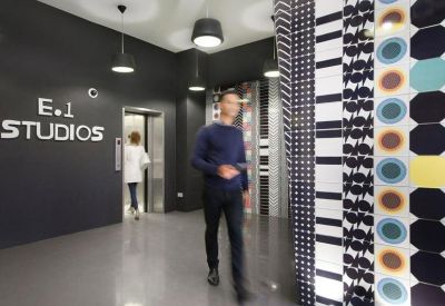 Branded reception area with monochrome patterns and dark grey feature walls.