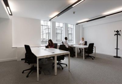 Bright four-person private office suite with large windows.
