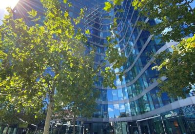 Exterior view of the curved glass facade of the Filadelfie building at Želetavská 1525/1.