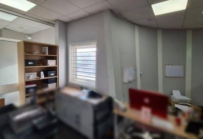 Bright workspace with wooden shelving and a window with blinds.