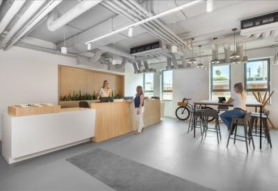 Minimalist reception area with a wooden front desk and bike rack.