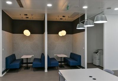 Comfortable blue booth seating pods for focused work or small meetings.