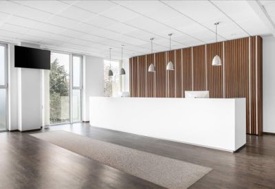 Minimalist white reception desk set against a warm wood-slatted feature wall.