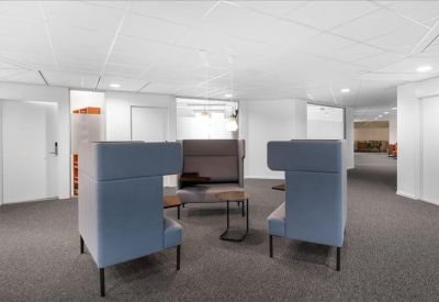 Private office suite with two workstations and a large window overlooking greenery.