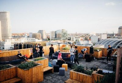 Rooftop terrace with seating and people enjoying the view.