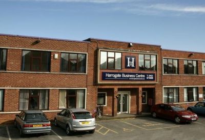 Main entrance of a two-story brick office building with signage above the doors.
