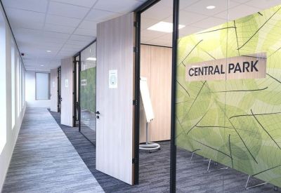 Glass-walled office entrance labeled Central Park with a leafy green privacy film.